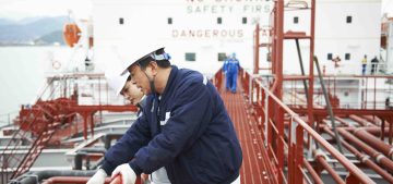 Two workers having discussion at shipping port, GoSeong-gun, South Korea